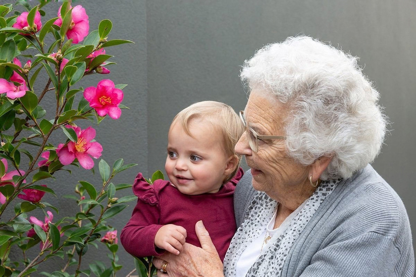 A resident holding a young grandchild