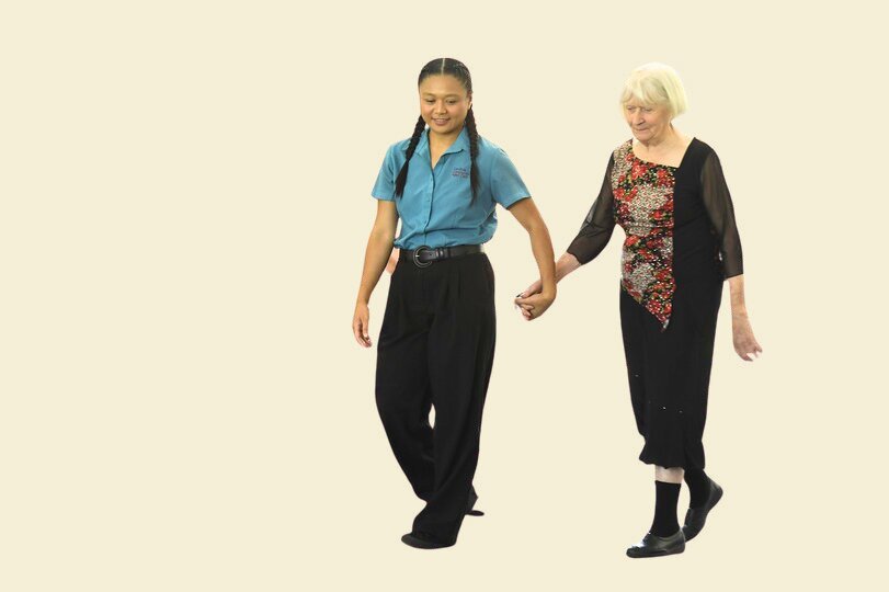 A team member walking hand in hand with a resident