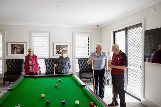 Residents playing billiards together
